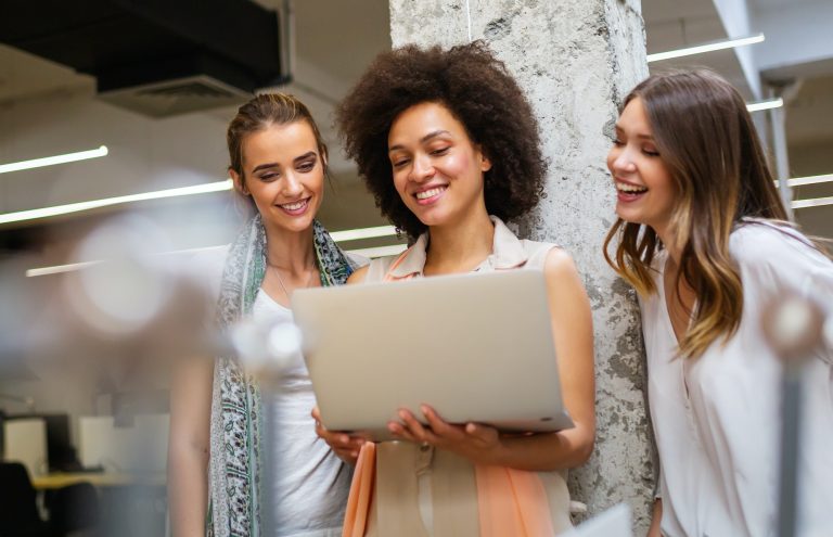Group of happy multiethnic business people having fun and chatting at workplace office